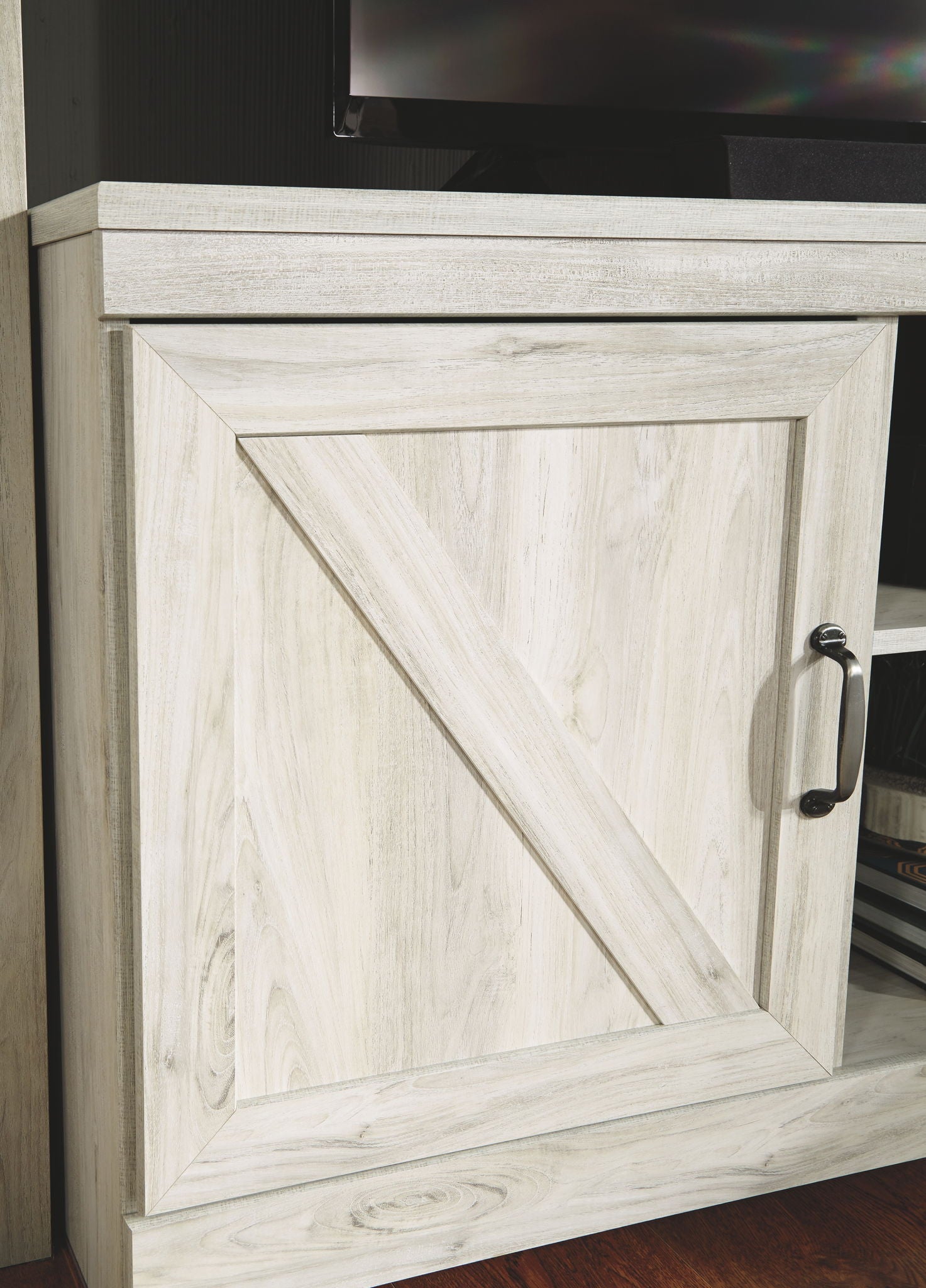 Beige cabinet door with diagonal panel detail and metal handle