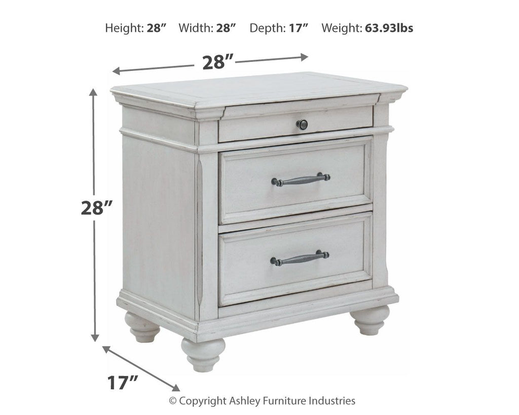 Whitewashed three-drawer nightstand with metal handles and turned legs, front view