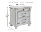 Whitewashed three-drawer nightstand with metal handles and turned legs, front view