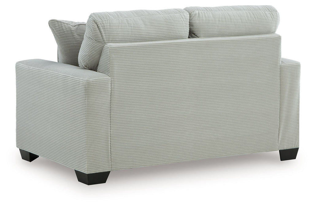 Upholstered loveseat with rolled arms and two back pillows, light upholstery