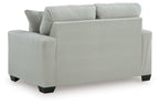 Upholstered loveseat with rolled arms and two back pillows, light upholstery