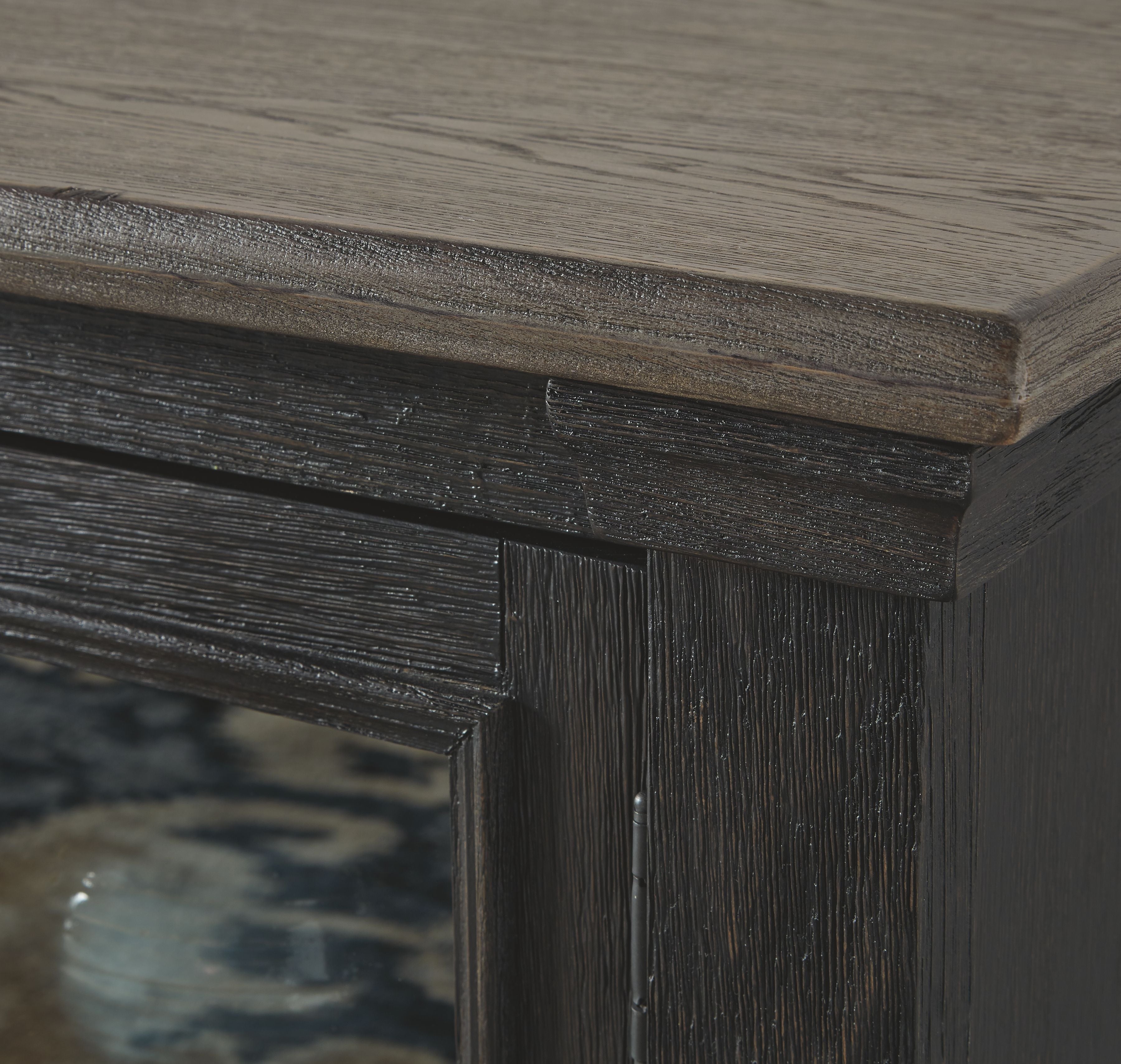 Dark cabinet door trim and wood grain detail on TV stand