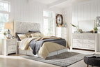 Whitewash dresser with decorative medallion drawer fronts and round knobs