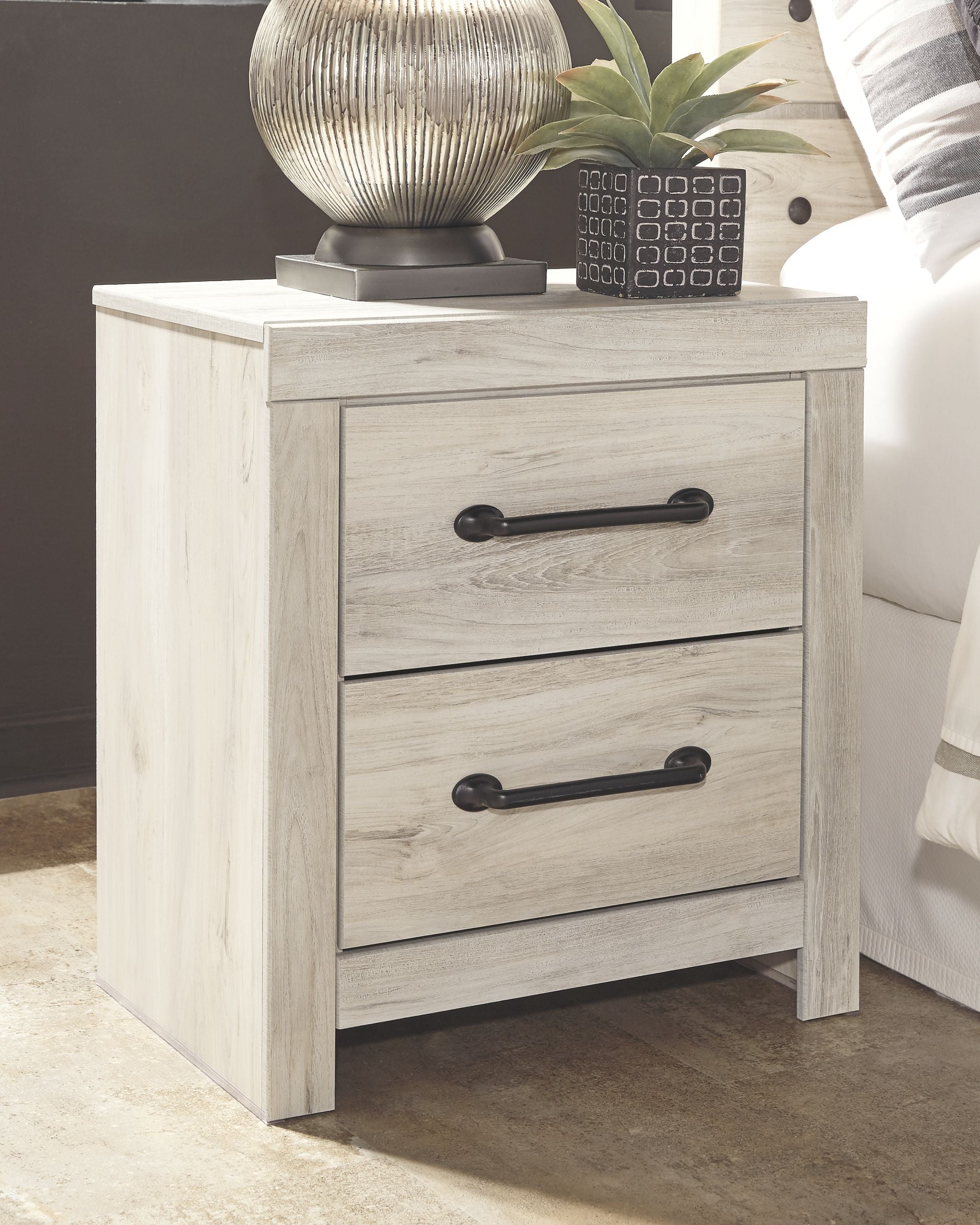 Whitewash two-drawer night stand with dark metal bar pulls and simple legs