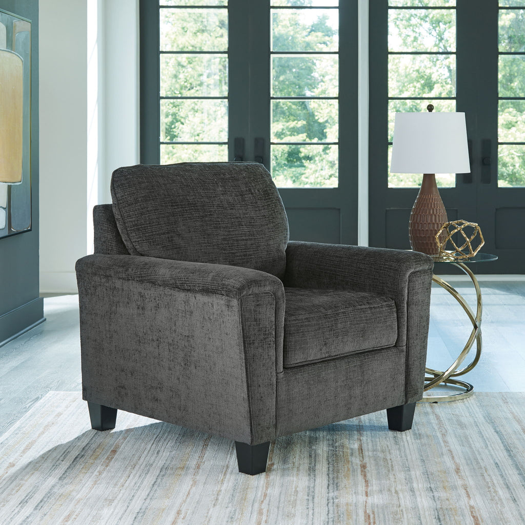 Dark gray upholstered armchair with high backrest and wide cushioned seat