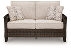 Dark brown wicker loveseat with two seat cushions and two patterned pillows