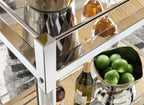 Glass shelves and reflective silver corner details on a bar cart