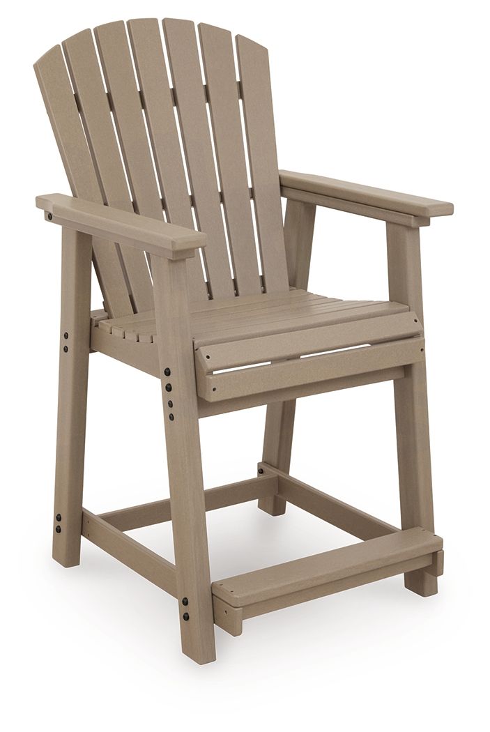 Set of 2 light brown wooden barstools with slatted back and wide armrests.