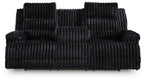 Black corduroy reclining sofa with plush backrest and padded armrests