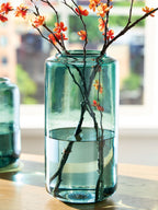 Teal glass square-edged vase with branches and orange blossoms
