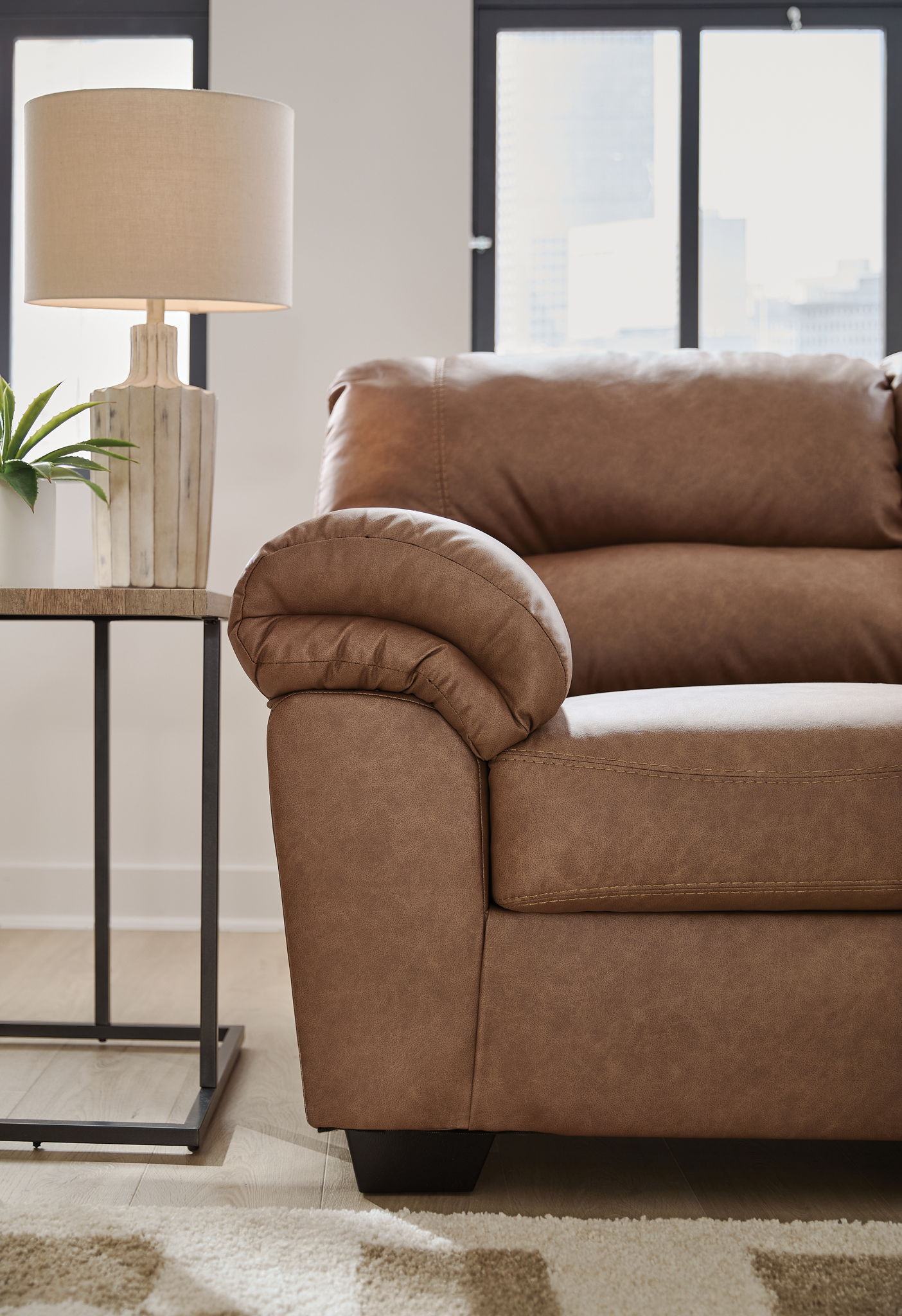Rolled-arm sectional chaise with tufted cushions, warm brown upholstery