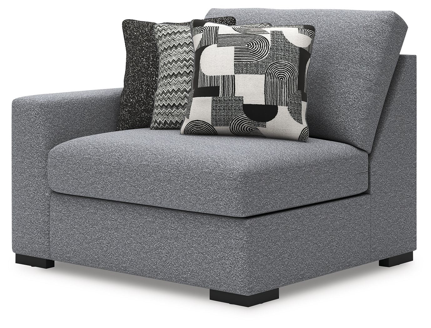 Gray upholstered corner chair with square seat, black legs, and patterned throw pillows
