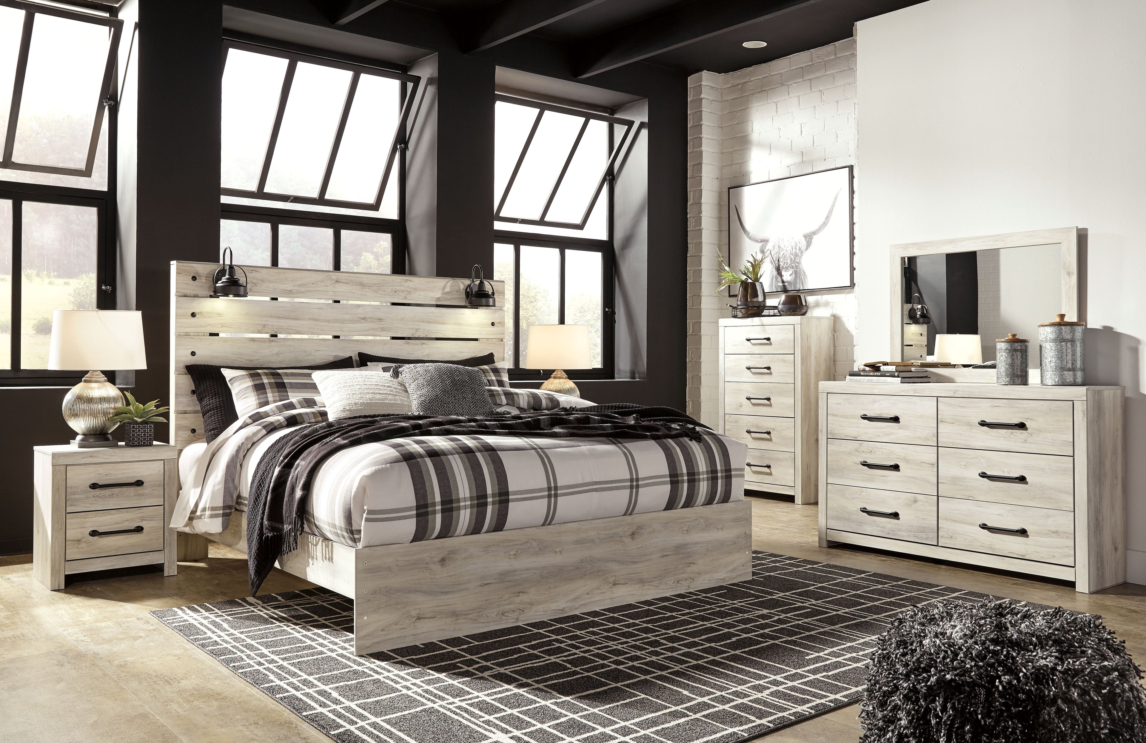 Bedroom set with light wood bed frame, black-and-white plaid bedding, and matching dresser with drawers