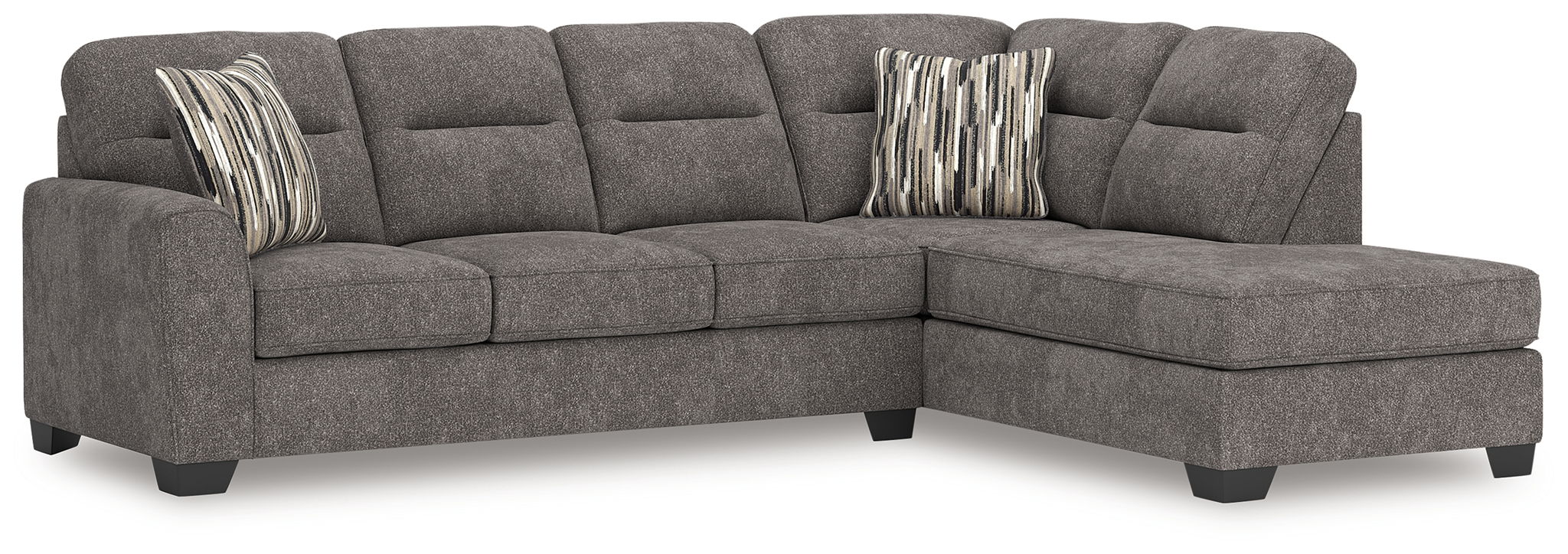 Dark gray L-shaped sectional sofa with right chaise, tufted back, and two striped throw pillows