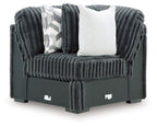 Gunmetal corduroy-style wedge sofa with tufted cushions and two throw pillows