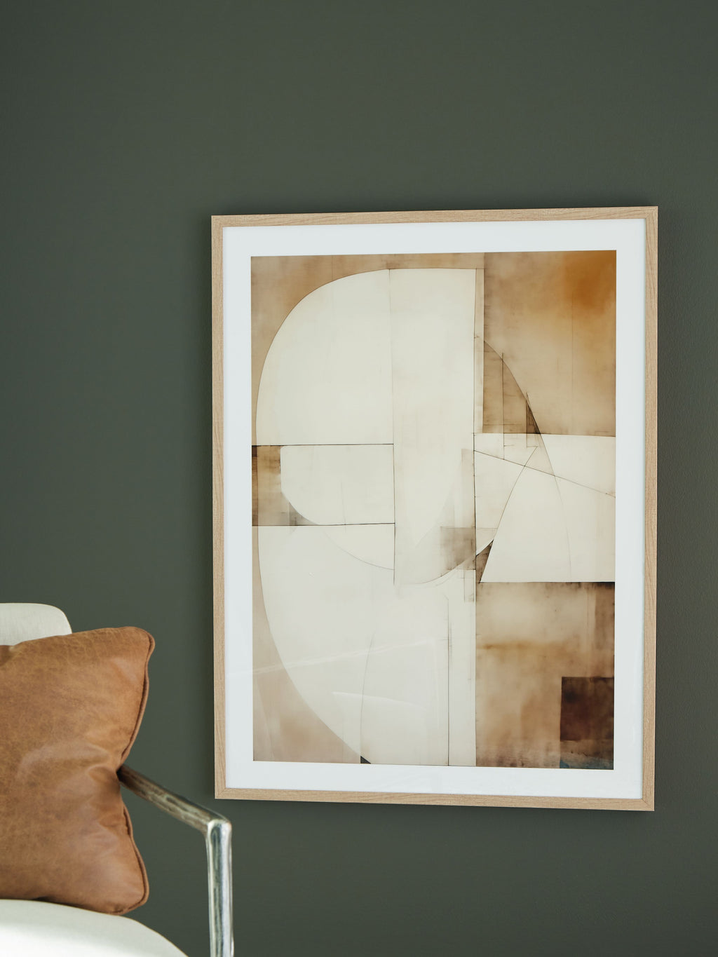 Framed abstract wall art print with layered white, tan, and brown geometric sections.