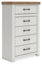 White chest of drawers with five drawers, brown top, and dark metal bar handles