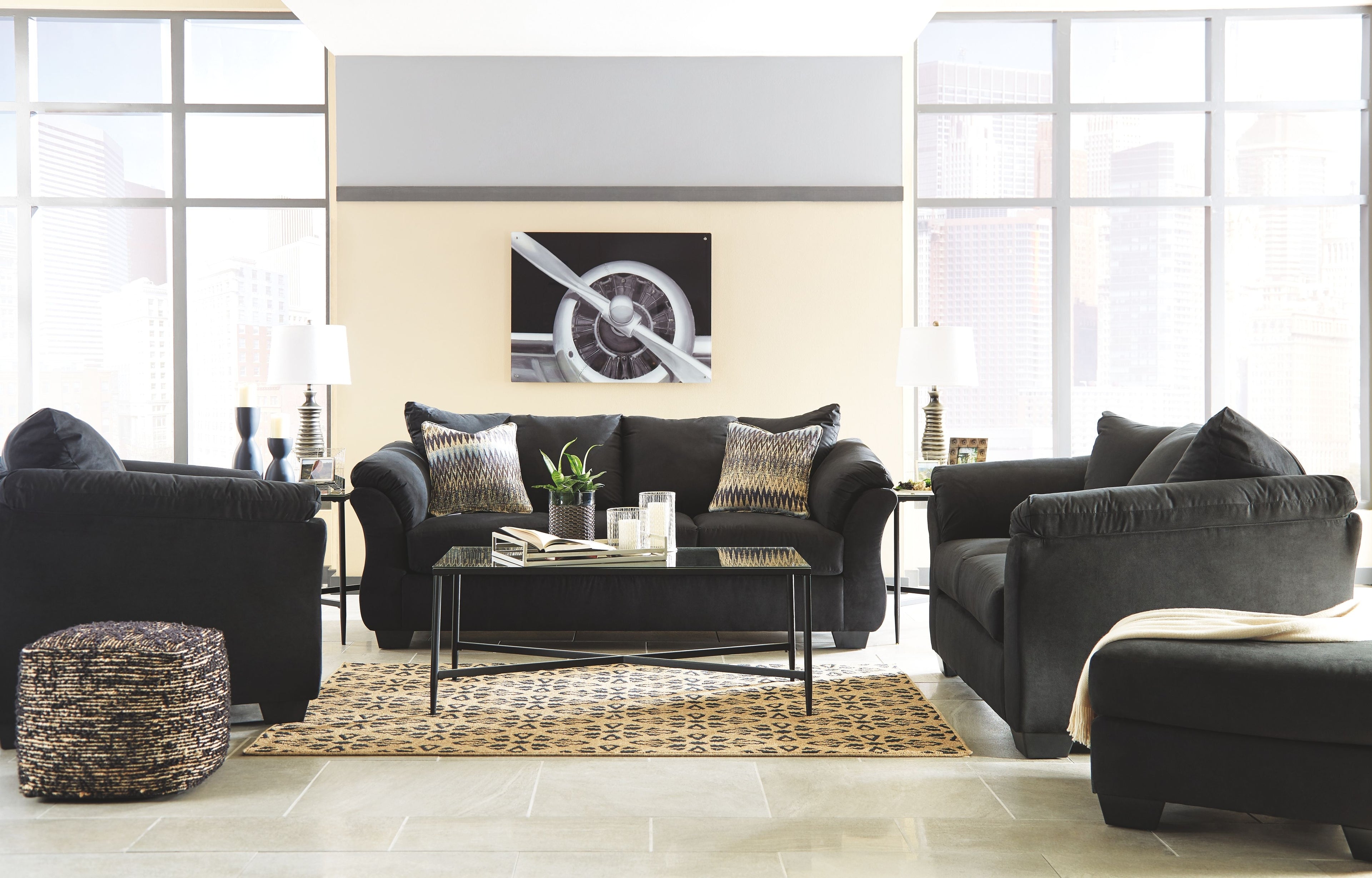 Living room set with dark sofa and loveseat, matching pillows and padded track arms