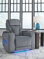 Dark gray fabric power recliner with padded armrests and headrest, glowing base light