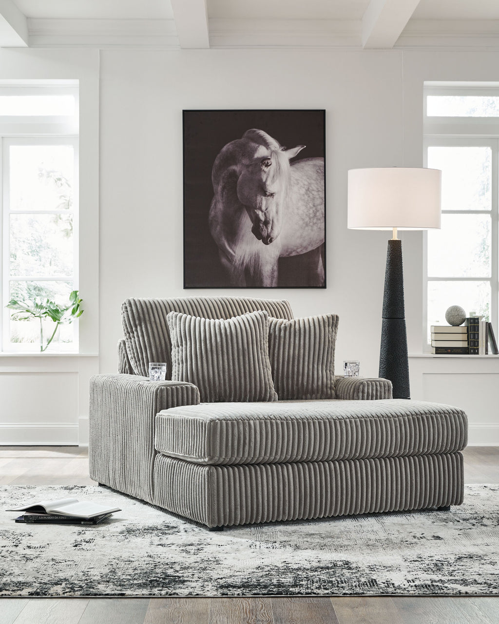 Corduroy chaise lounge chair in light gray with striped texture and two back cushions.
