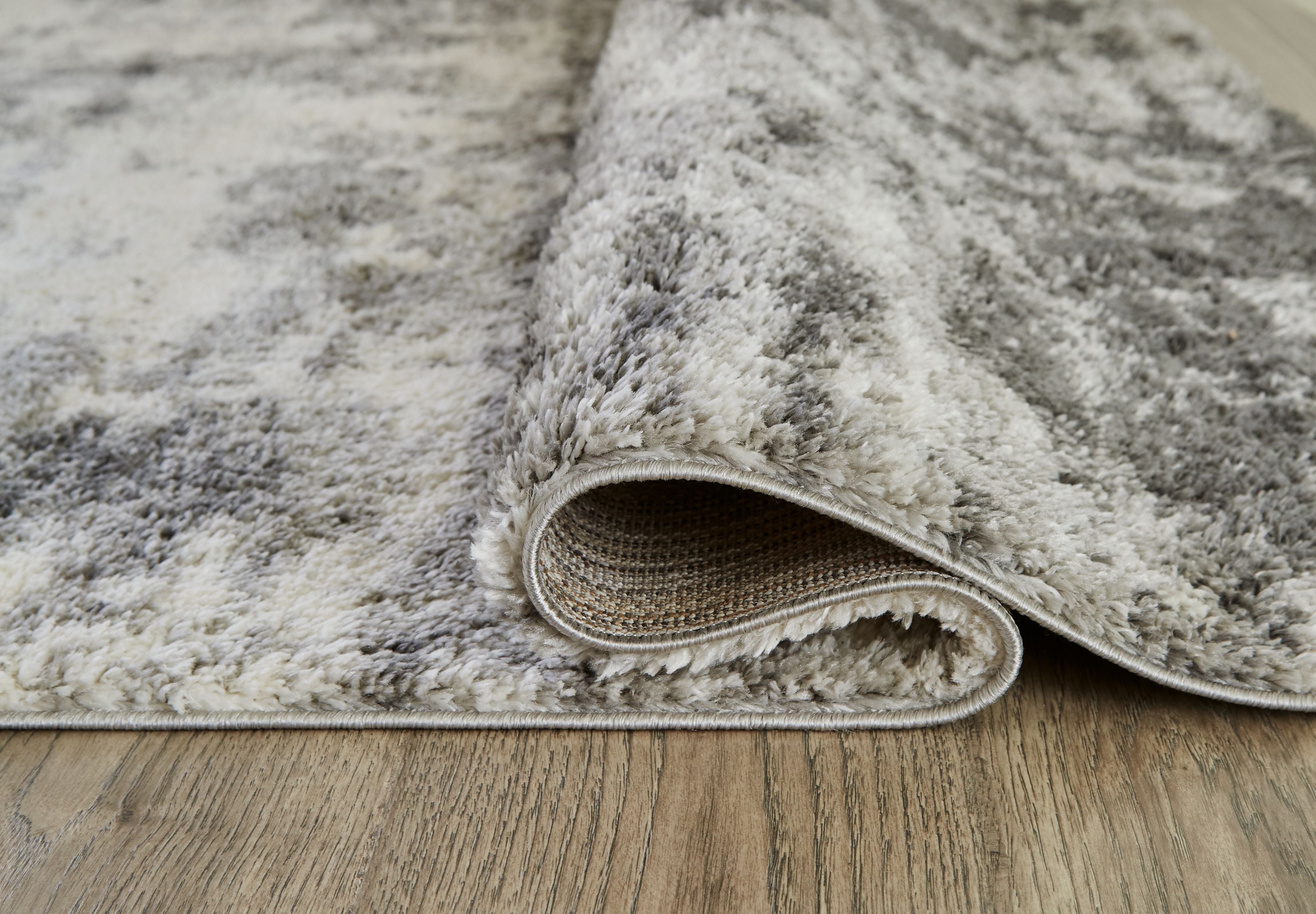 Pearl silver shag rug close-up showing flipped edge and distressed abstract pile