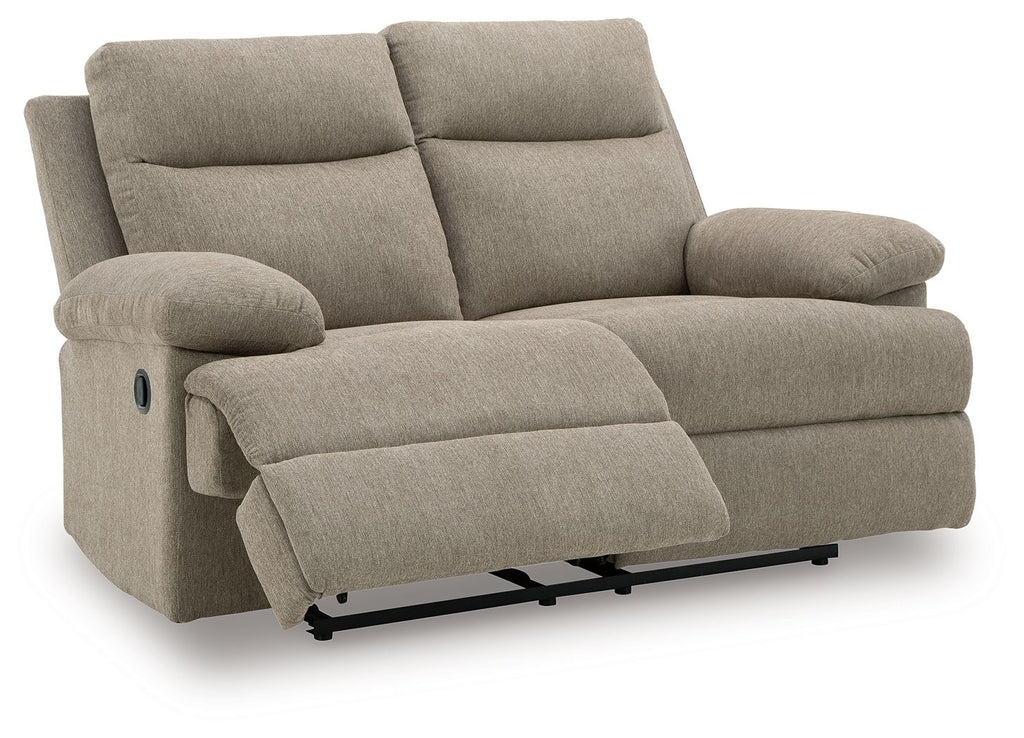 Beige reclining loveseat with curved armrests and extended leg rest panel