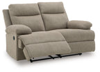 Beige reclining loveseat with curved armrests and extended leg rest panel