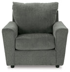 Gray upholstered armchair front view with padded arms, seat cushion, and tall back
