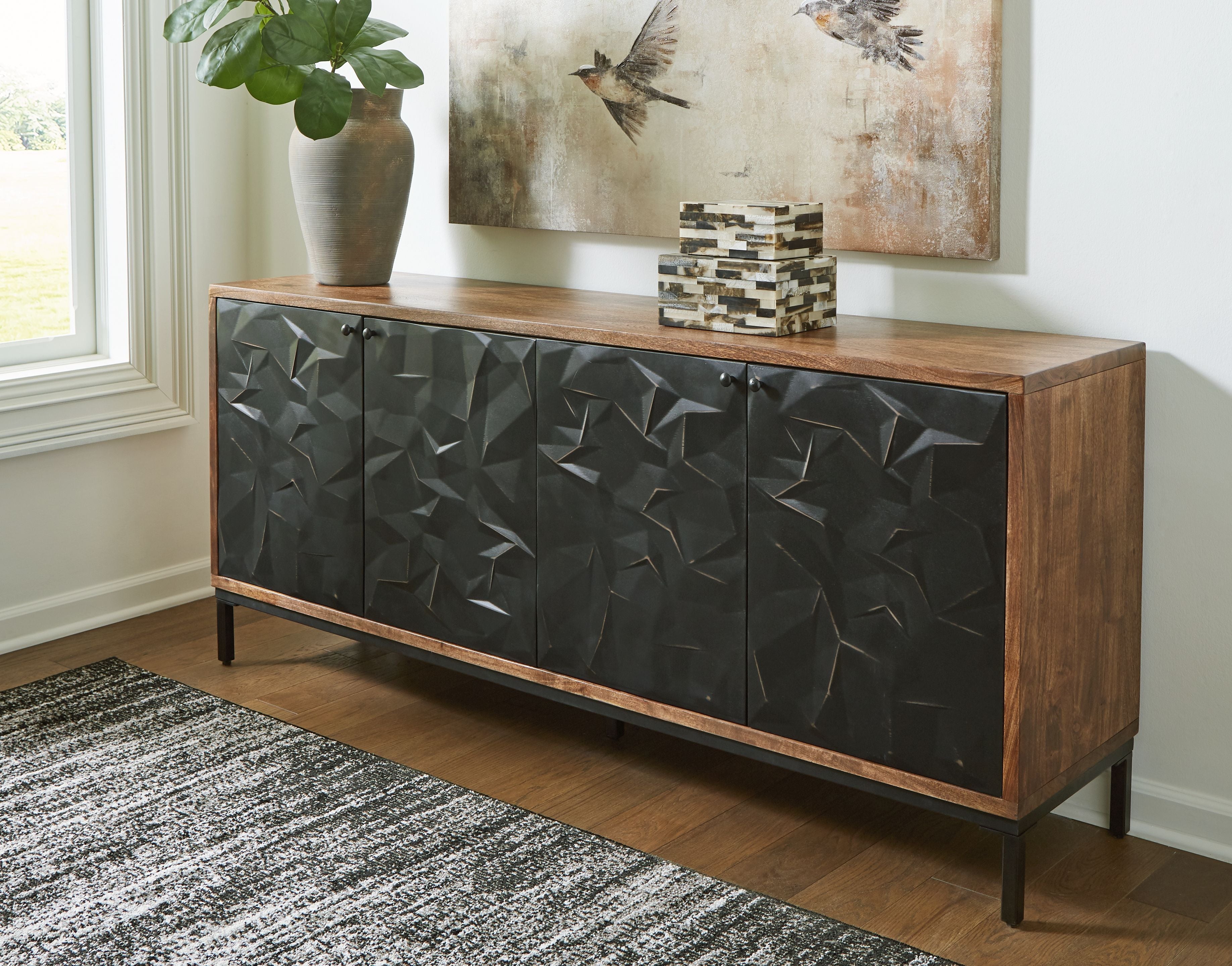 Accent cabinet with geometric black doors, wood sides, and long top rail