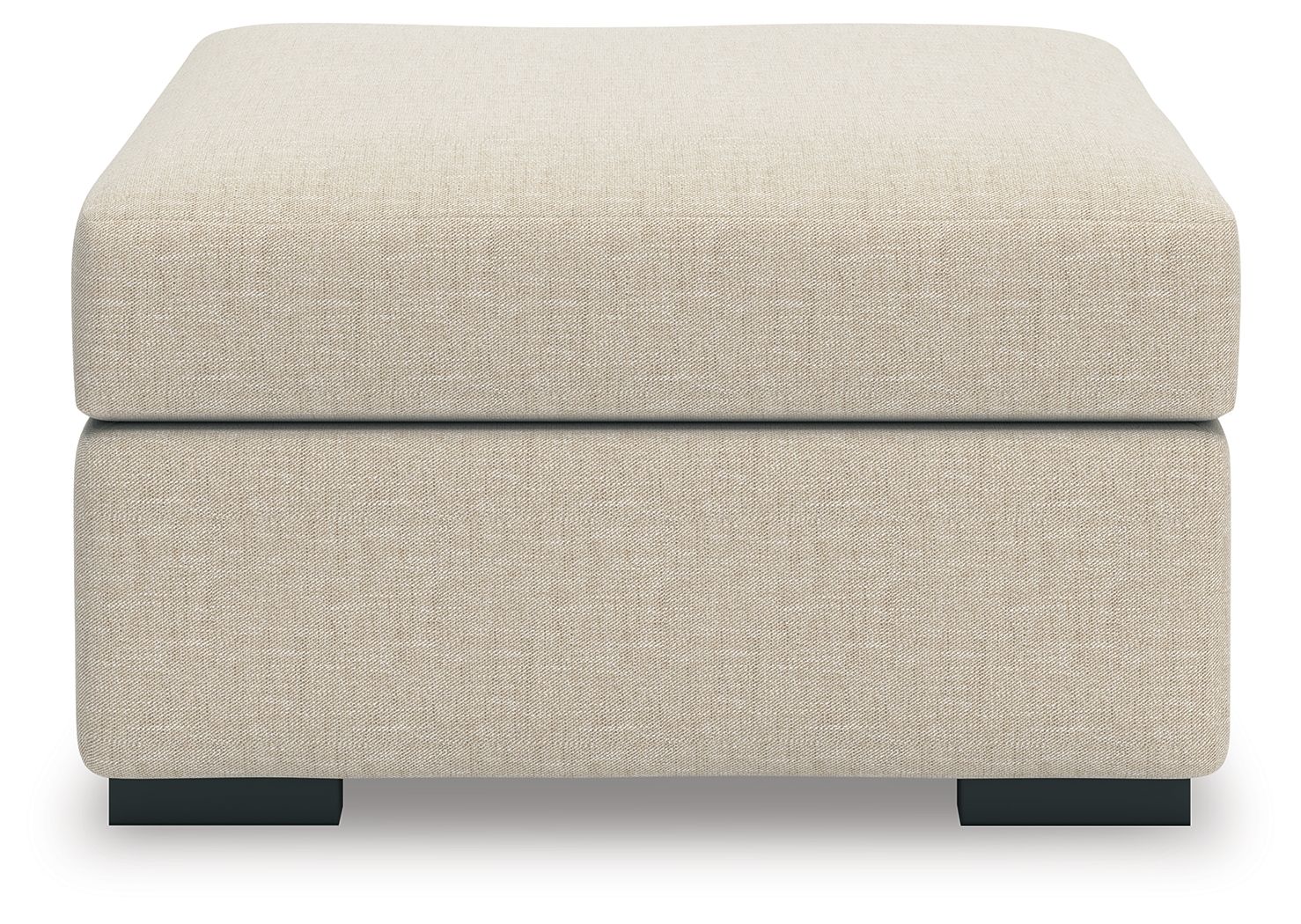 Light beige upholstered ottoman with thick padded top and black block feet