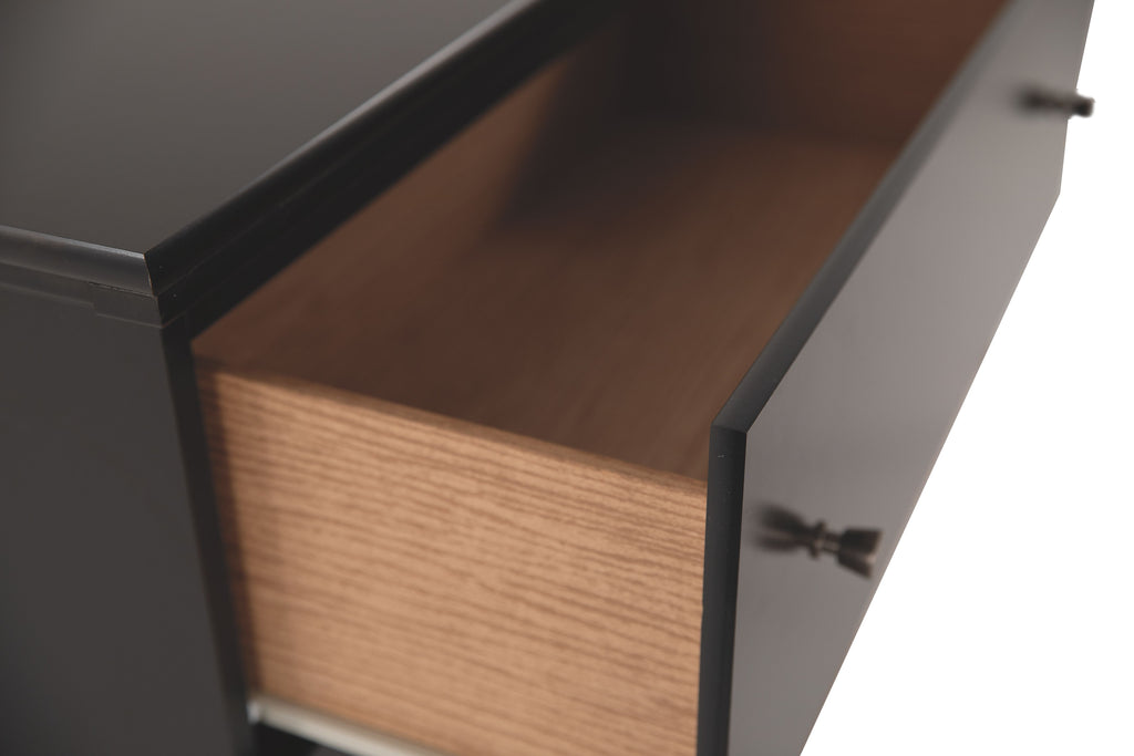 Wooden drawer interior with dark dresser cabinet, open side view