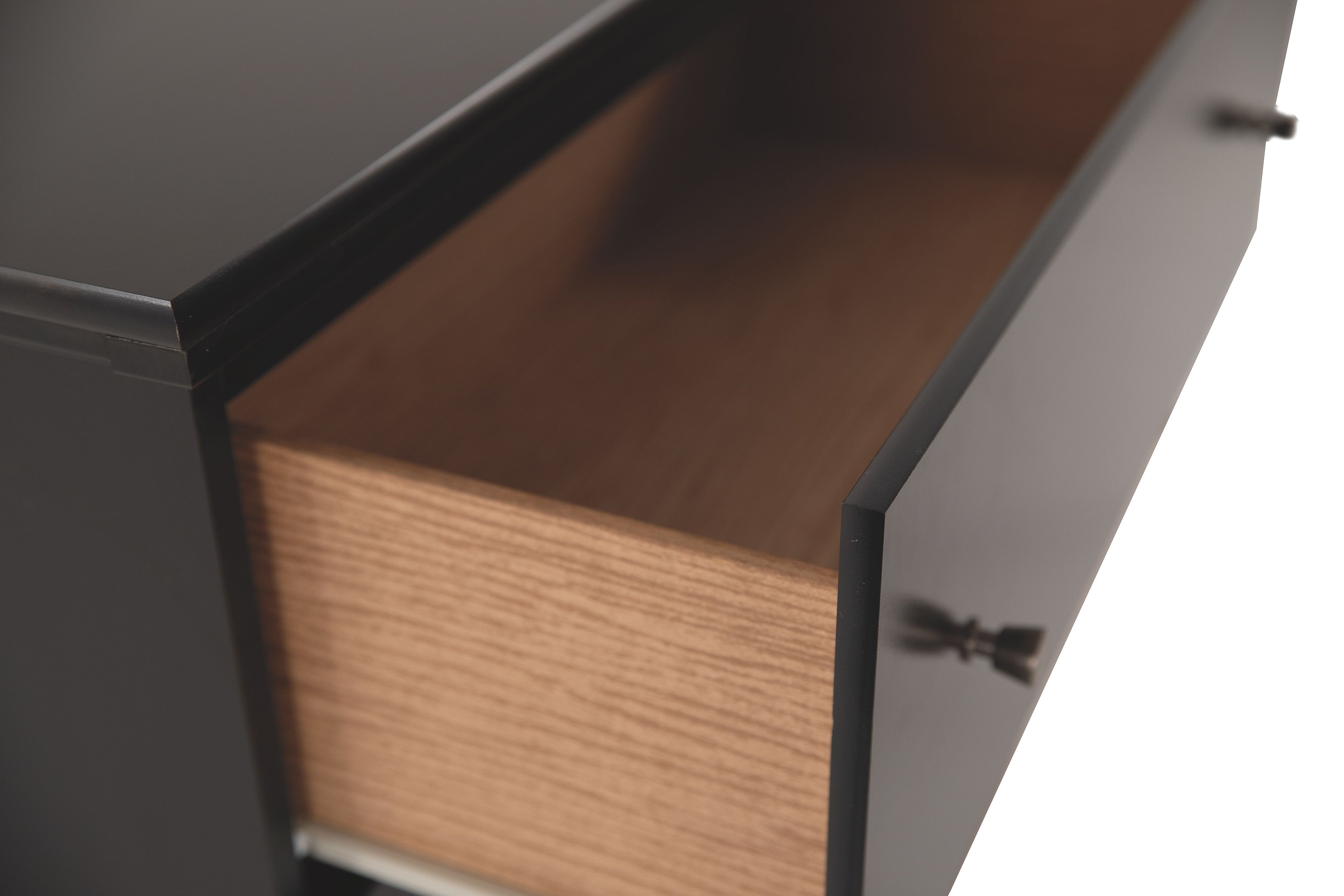 Wooden drawer interior with dark dresser cabinet, open side view
