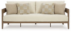 Outdoor lounge loveseat with beige cushions and two patterned pillows, straight back