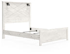 White panel bed frame with two black sconces, side view of slatted headboard