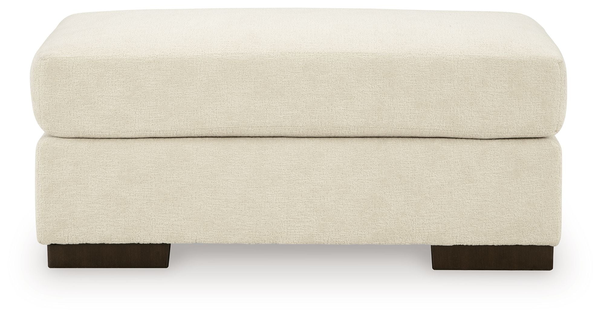 Beige fabric ottoman with padded top and dark legs.