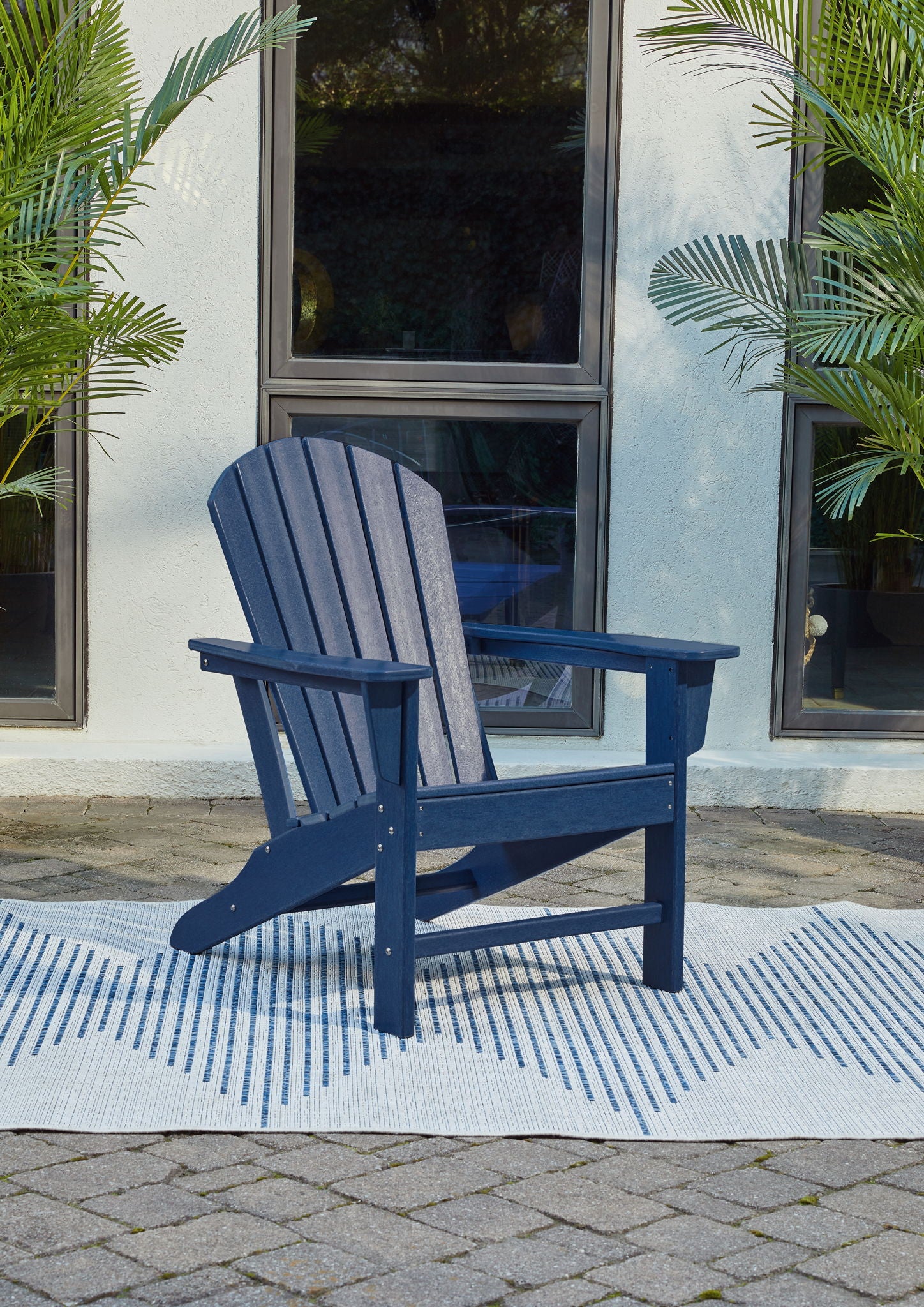 Outdoor adirondack chair, blue slatted back and armrests