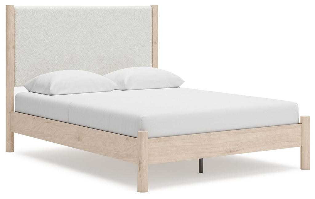 Beige upholstered panel bed with light wood frame and slatted base