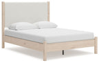 Beige upholstered panel bed with light wood frame and slatted base