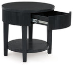 Black round end table with ribbed sides and open storage drawer