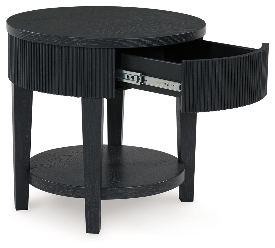 Black round end table with ribbed sides and open storage drawer