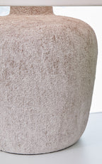 Textured gray stone-look lamp base with metal pedestal and round silhouette