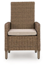 Beige armchair with woven wicker sides and back, light seat cushion, wooden legs