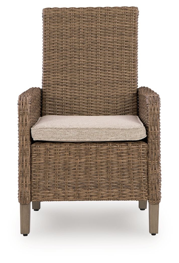 Beige armchair with woven wicker sides and back, light seat cushion, wooden legs