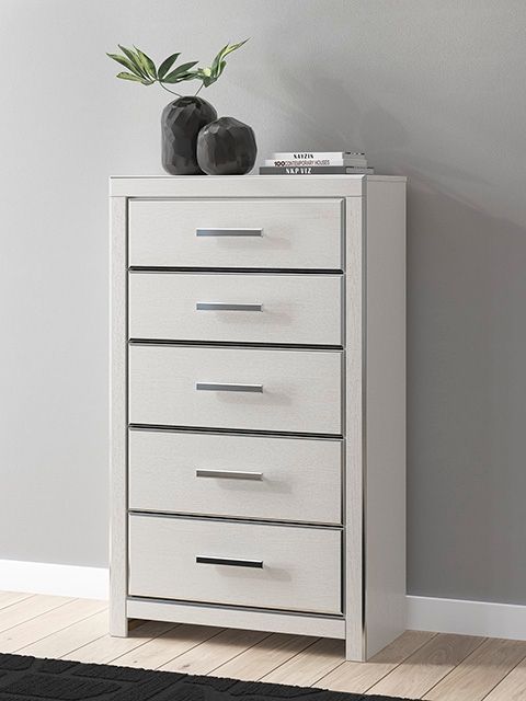 White five-drawer chest with silver bar pulls on five stacked drawers