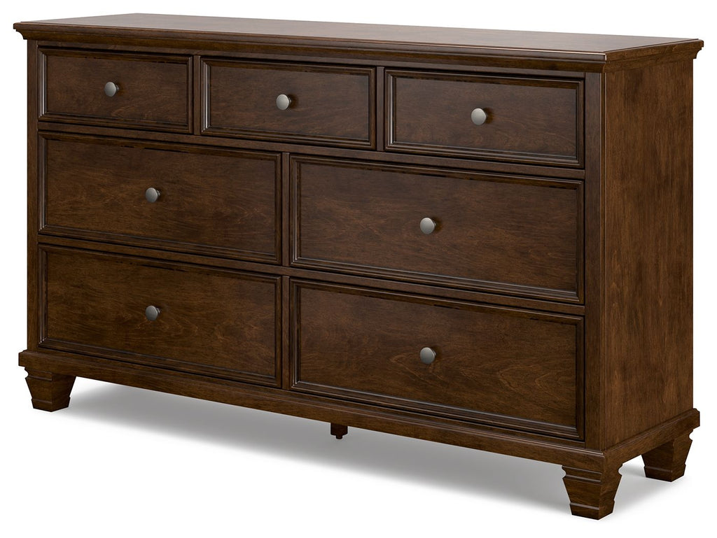 Brown dresser with six front drawers and round knobs, squared bun feet