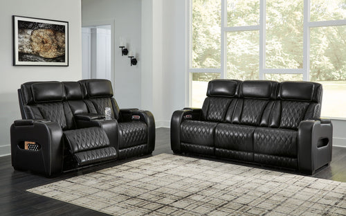 Black quilted power reclining loveseat with two seats and armrest controls