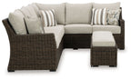 Brown wicker sectional sofa with beige cushions and ottoman benches