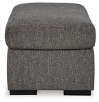 Pewter upholstered ottoman with rounded sides and black base