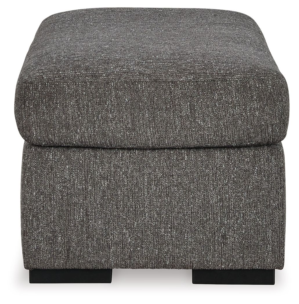 Pewter upholstered ottoman with rounded sides and black base