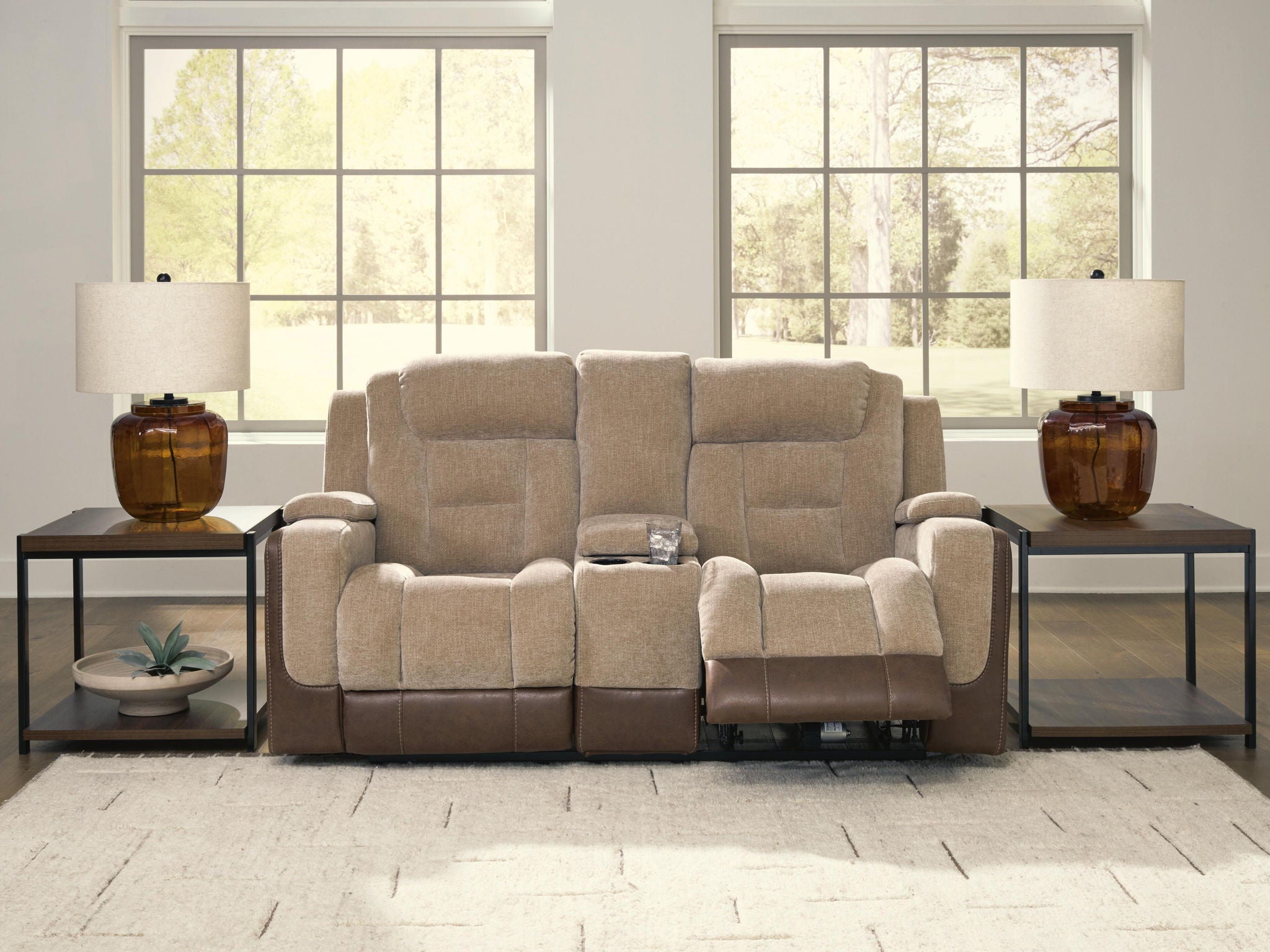 Power reclining loveseat with adjustable headrests, beige upholstery and two-tone arms.